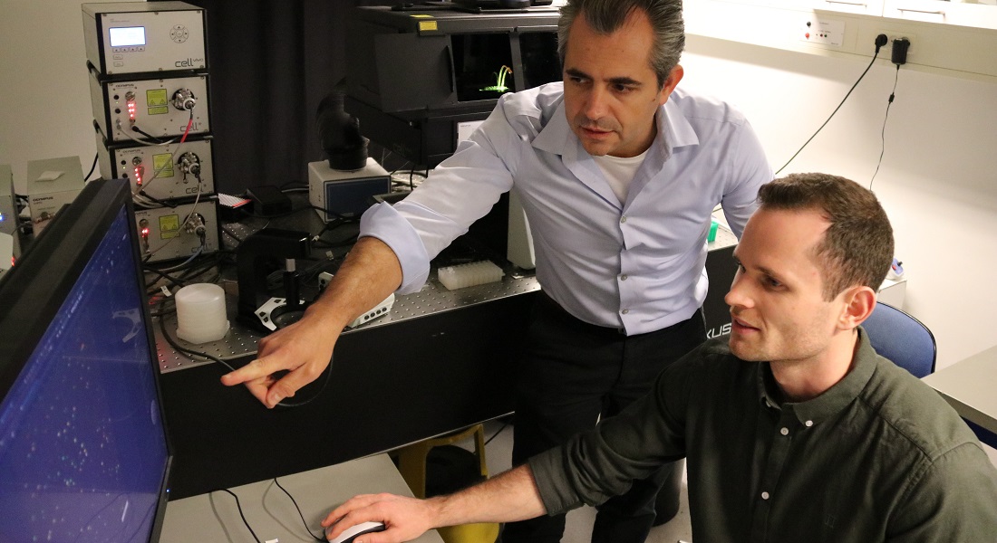 Nikos Hatzakis and Simon Bo Jensen operating the advanced fluorescence microscope. Credit: Shunliang Wu