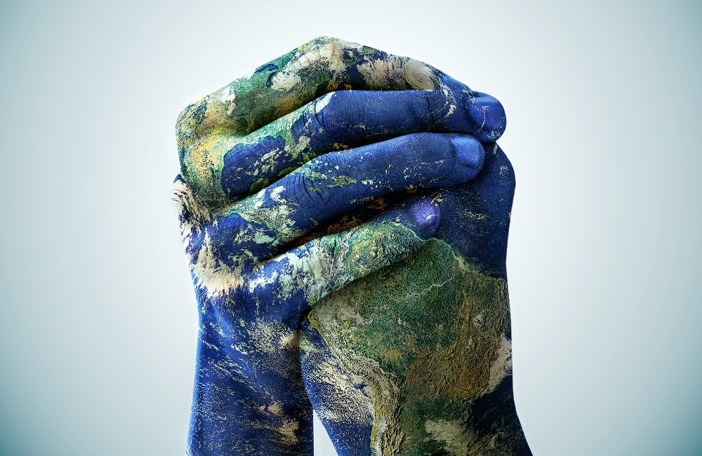 Photo of hands painted like the earth